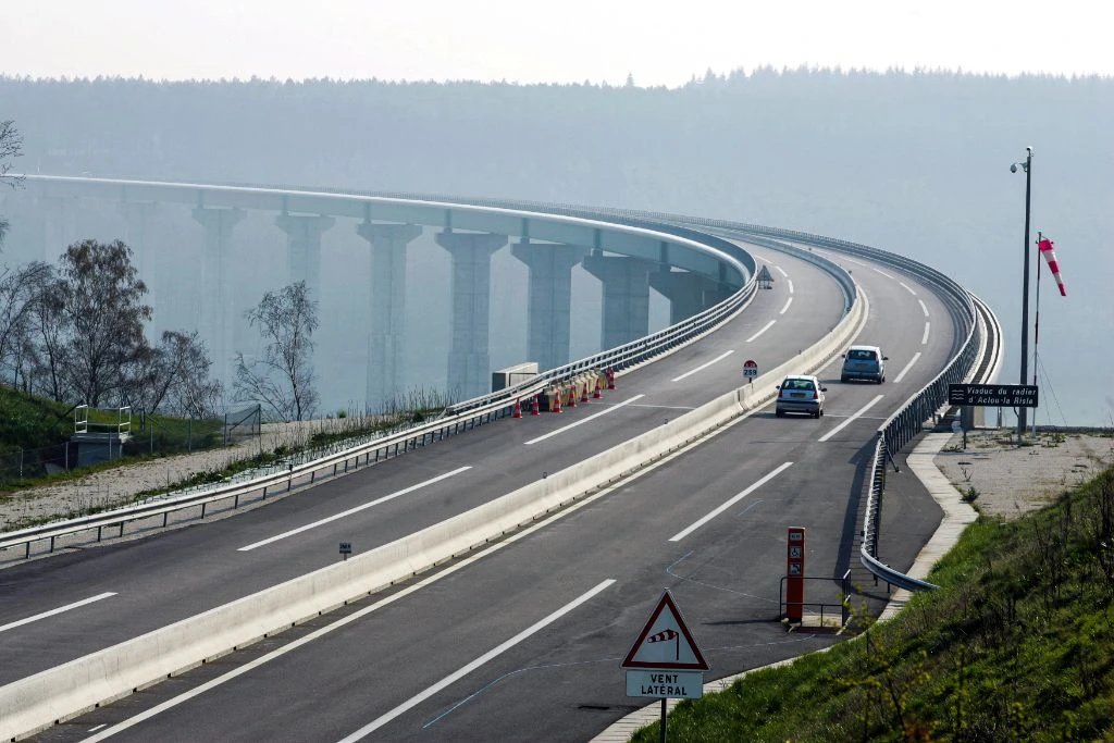 Curved highway with foggy viaduct in background